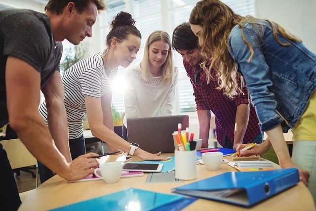 A group of office workers around a workshop table